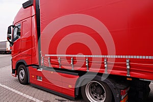 Truck with semi-trailer with covered tarpaulin. Transport and unloading