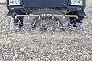 Truck sprays water on new road construction site