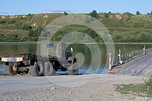 A truck standing on the river bank