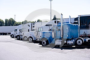 Truck stop with row of big rigs semi trucks