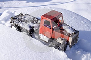 The truck is stuck in a snow trap.Transport in winter on a snow road