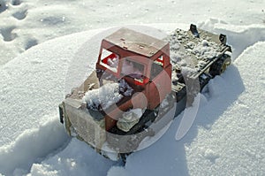 The truck is stuck in a snow trap.Transport in winter on a snow road