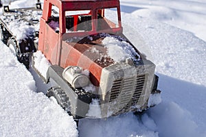 The truck is stuck in a snow trap.Transport in winter on a snow road