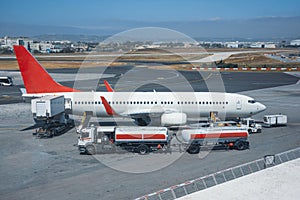 Truck with a tank and a trailer of aviation fuel during the refueling of the aircraft and its service before the flight