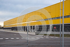 Truck terminal in yellow exterior color. Yellow warehouse. Logistics center with black terminals