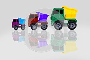 Truck toy mini, truck scale model made of plastic with multicolor isolated on grey background.