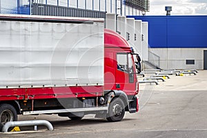 Truck with trailer on loading in logistics center. Transportation of goods