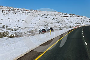 Truck trailer transports cars on highway with accident in snow off road