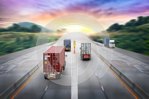 Truck transport with red container on highway road at sunset, motion blur effect, logistics import export background