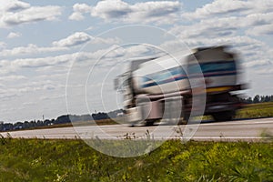 Truck transport on the road with motion blur. Blurred image back