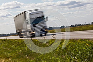 Truck transport on the road with motion blur. Blurred image back