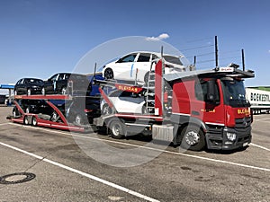 Truck transporting new Mercedes Benz automobiles