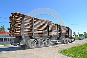The truck transports wood down the street. Poshekhonje, Yaroslavl region