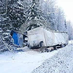 Truck turned over in a ditch on a snow-covered road