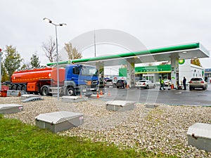 Truck unload petrol on filling station BP at day time