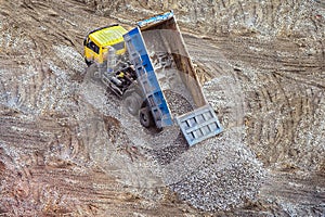 Truck unloads rubble breakstone to the ground