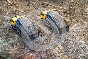 Truck unloads rubble to the ground view from above