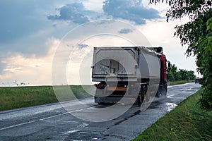 Truck vehicle driving wet road in rainy weather