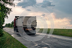 Truck vehicle driving wet road in rainy weather