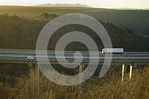 Truck on viaduct on the highway of La Plata, Salamanca dazzled by the sun