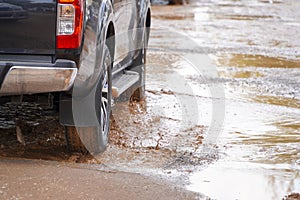 Truck wading through muddy country roads.safe driving