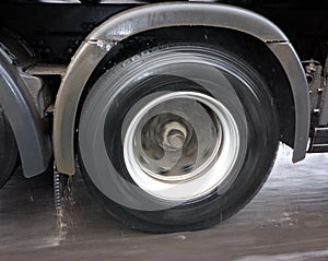 Truck wheel in motion on a wet road