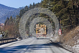 Truck with wood logs driving