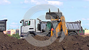 Truck and yellow excavator - tractor on a working platform â€“ time lapse speed 60x