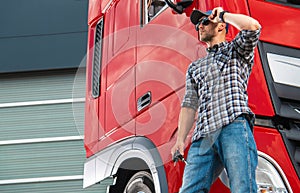 Trucker in Front of His Brand New Semi Truck Tractor