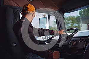 Trucker in His 40s Inside Vintage Aged Semi Truck Tractor Cabin