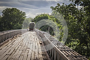 Trucks crossing a wooden bridge