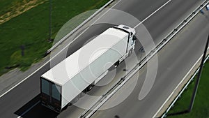 Trucks drive along the highway on a sunny day. Aerial Follow Shot.