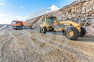 Trucks and excavators moving earth for the construction of a highway