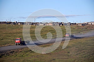 Trucks at gravel road abandoned town Chukotka