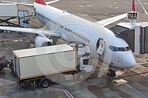 Trucks with a lift providing in-flight catering for a passenger airliner jet