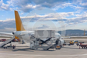 Trucks with a lift providing in-flight catering for a passenger airliner jet.