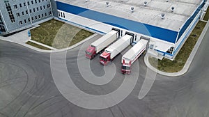 Trucks are loaded in a modern logistics center