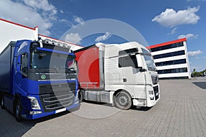 Trucks loading at a depot of a forwarding agency - Transport and logistics in goods trade