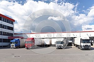 Trucks loading at a depot of a forwarding agency - Transport and logistics in goods trade