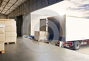 Trucks Loading Package Boxes Pallets at Dock Warehouse. Container Shipping. Freight Truck Logistics Cargo Transport.