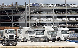 Trucks and luxury cars await export from docks UK