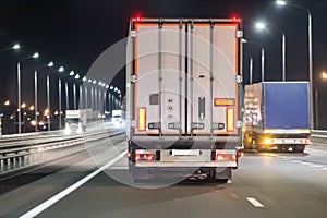 Trucks move on a night freeway