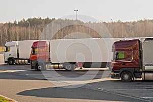 Trucks parked in a roadside parking lot. Autumn cold morning