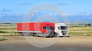 Trucks on parking against landscape