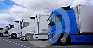 Trucks at parking lot. Delivery Trucks. Cargo Shipping. Lorry. Industry Freight Truck Logistics Cargo Transport Concept.