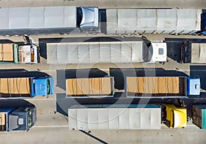 Trucks in the parking lot, top view on a truck. Logistics transport in the parking lot waiting for unloading.