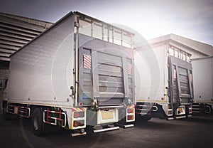 Trucks Parking at The Warehouse. Truck with Lift Ramp. Cargo Freight Transportation.