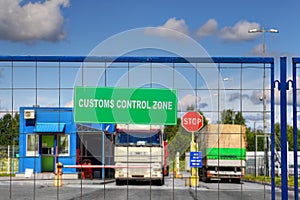 Trucks pass through checkpoint of customs logistics terminal. photo