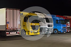 Trucks semi-trailers in the parking lot at night