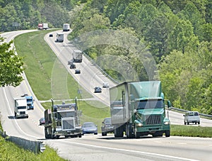 Trucks and traffic on hilly highway